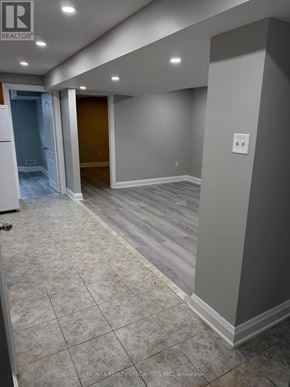 Brampton (Bram West) apartment for rent - A hallway with tile flooring and a light switch on the wall.