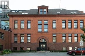 Hamilton (Stinson) condo for rent - A red brick building with a black door and windows.