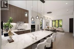 Vancouver apartment for rent - A modern kitchen with a marble countertop and a dining area with white chairs.