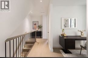 Vancouver apartment for rent - A hallway with a staircase and a desk with a plant on it.