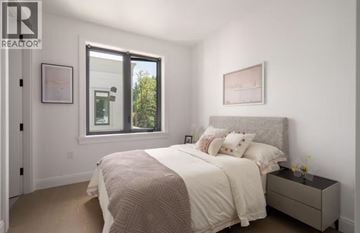 Vancouver apartment for rent - A bedroom with a large bed and a window.