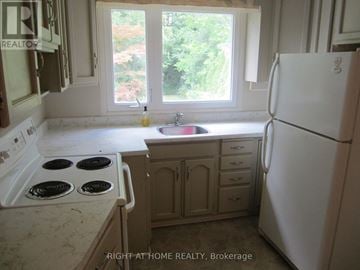 Toronto (Willowdale West) apartment for rent - A kitchen with a white fridge, stove and sink.