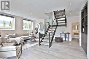 Toronto (Rosedale-Moore Park) townhouse for rent - A modern living room with a spiral staircase and a glass railing.