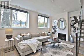 Toronto (Rosedale-Moore Park) townhouse for rent - A living room with a white couch and a fireplace.