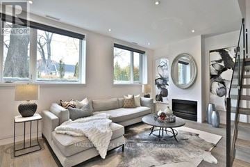 Toronto (Rosedale-Moore Park) townhouse for rent - A living room with a white couch and a fireplace.