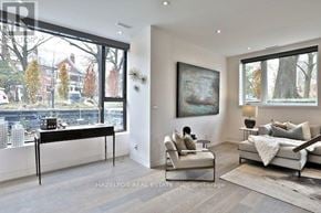 Toronto (Rosedale-Moore Park) townhouse for rent - A modern living room with a large window overlooking a cityscape.