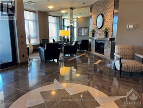 Ottawa condo for rent - A living room with a stone fireplace and a large mirror on the wall.