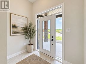 Russell townhouse for rent - A white door with a glass window is open to a bright outdoor area.