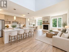 Russell townhouse for rent - A modern kitchen with a bar area and a living room area.