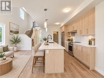 Russell townhouse for rent - A well-lit kitchen with wooden cabinets and a central island.