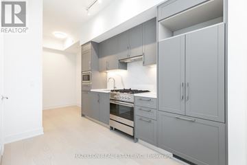 Toronto (Yonge-Eglinton) condo for rent - A modern kitchen with a stove top oven and a range hood.