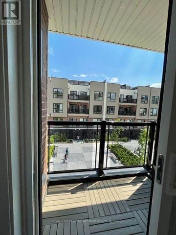 Toronto (Rouge) townhouse for rent - A balcony view of apartment buildings with a clear blue sky.