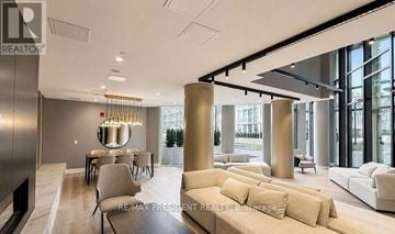 Oakville (Jm Joshua Meadows) condo for rent - A modern living room with a dining table and a large window.