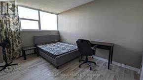 St. Catharines (Glendale/Glenridge) condo for rent - A bedroom with a bed, desk, and chair.