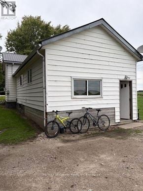 South-West Oxford (Brownsville) apartment for rent - A small white house with a bicycle leaning against it.