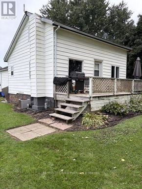 South-West Oxford (Brownsville) apartment for rent - A white house with a deck and a grill.