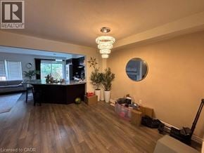 Cambridge townhouse for rent - A well-lit living room with a kitchenette and a large mirror on the wall.
