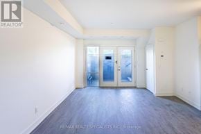 St. Catharines (E. Chester) townhouse for rent - A spacious room with a doorway leading to another room.