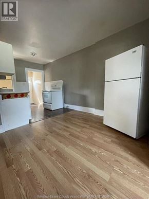 Windsor apartment for rent - A kitchen with a white fridge and wooden floors.