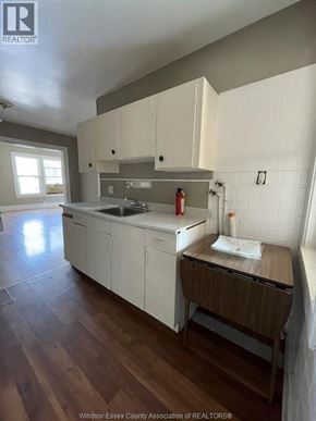 Windsor apartment for rent - A kitchen with white cabinets and a wooden island.
