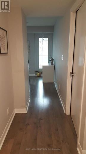 Toronto (Waterfront Communities) condo for rent - A hallway with wood floors and white walls.