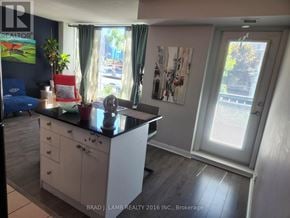 Toronto (Waterfront Communities) condo for rent - A kitchen with white cabinets and a black countertop.
