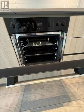 Toronto (Waterfront Communities) condo for rent - A modern oven with a digital display and control panel is built into a kitchen countertop.