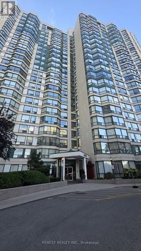 Mississauga (Hurontario) condo for rent - A tall building with many windows is shown in the image.