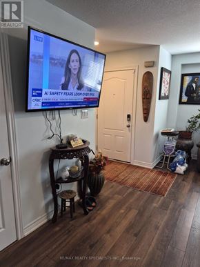 Niagara Falls (Ascot) house for rent - A TV screen shows a news program about AI safety fears looming over the horizon.