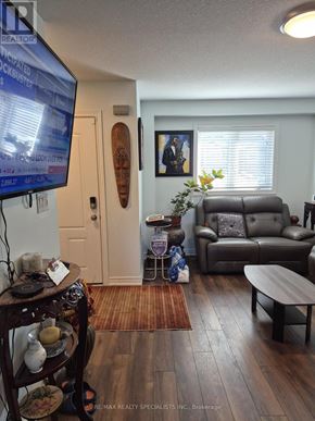 Niagara Falls (Ascot) house for rent - A living room with a flat screen TV mounted on the wall.