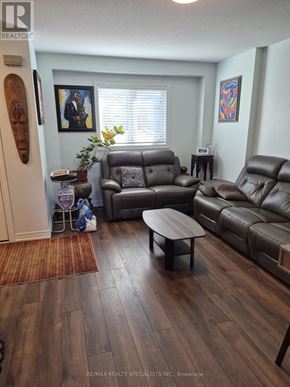 Niagara Falls (Ascot) house for rent - A living room with brown leather furniture and a wooden floor.