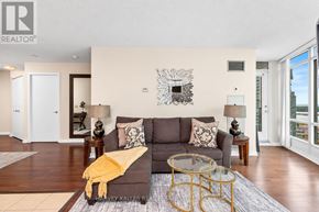 Toronto (Waterfront Communities) condo for rent - A living room with a grey couch and a yellow throw pillow.