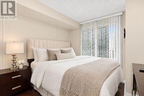 Toronto (Waterfront Communities) condo for rent - A bedroom with a large bed and a window with blinds.
