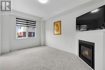 Centre Wellington (Fergus) apartment for rent - A living room with a fireplace and a television on the wall.