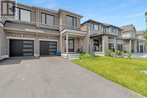 Centre Wellington (Fergus) apartment for rent - A large, modern house with a brick facade and a driveway in front.
