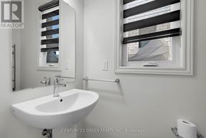 Centre Wellington (Fergus) apartment for rent - A white sink in a bathroom with a roll of toilet paper on the side.