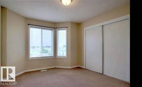Edmonton townhouse for rent - A room with a sliding door, a window, and a ceiling light.