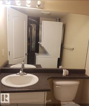 Edmonton townhouse for rent - A bathroom with a sink, toilet and a small refrigerator.