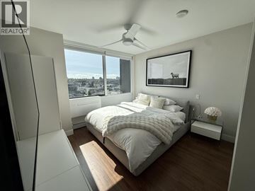 Vancouver apartment for rent - A living room with a black chair and a television.