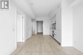 Toronto (Thorncliffe Park) condo for rent - A spacious, empty room with white walls and wooden flooring.