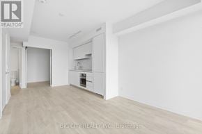 Toronto (Thorncliffe Park) condo for rent - A spacious room with a kitchenette and a large empty wall.
