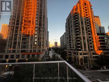 Toronto (Mount Pleasant West) condo for rent - Two tall buildings with orange lighting and a street in between.