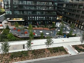 Toronto (Mount Pleasant West) condo for rent - A view of a courtyard with a fountain and seating area in front of a building.