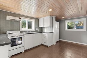 Chilliwack apartment for rent - A kitchen with white appliances and cabinets.