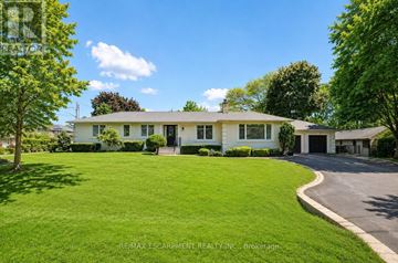 Oakville (Fd Ford) apartment for rent - A white house with a green lawn in front.