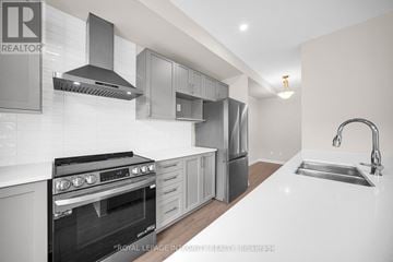 Ottawa townhouse for rent - A modern kitchen with a stove top oven and a sink.