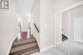 Ottawa townhouse for rent - A hallway with a staircase leading to the second floor.