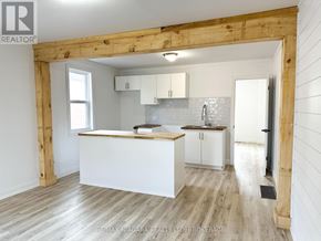 St. Catharines (Western Hill) apartment for rent - A kitchen with white cabinets and a wooden beam ceiling.