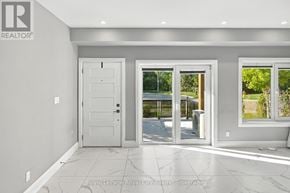 Kitchener condo for rent - A white door is in a room with a tiled floor.