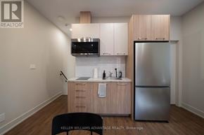 Toronto (Kensington-Chinatown) apartment for rent - A cityscape with buildings and cars.